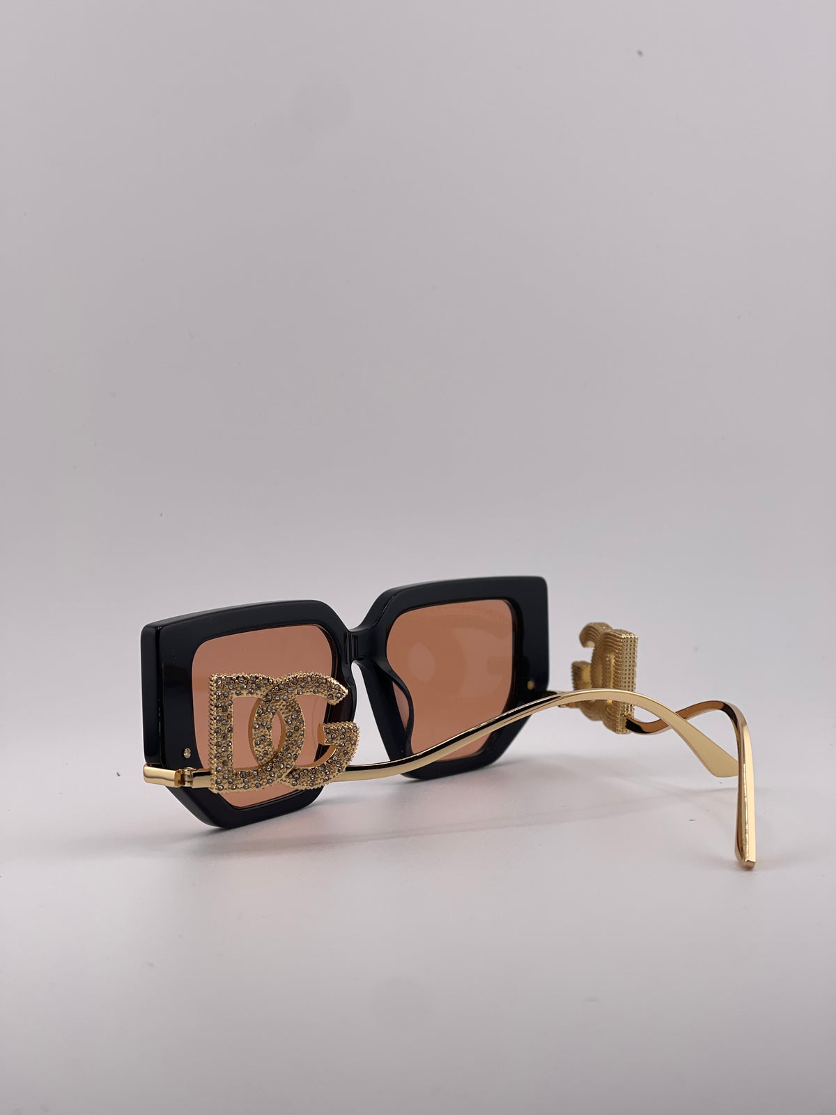 Dolce & Gabbana black square sunglasses with pink-tinted lenses