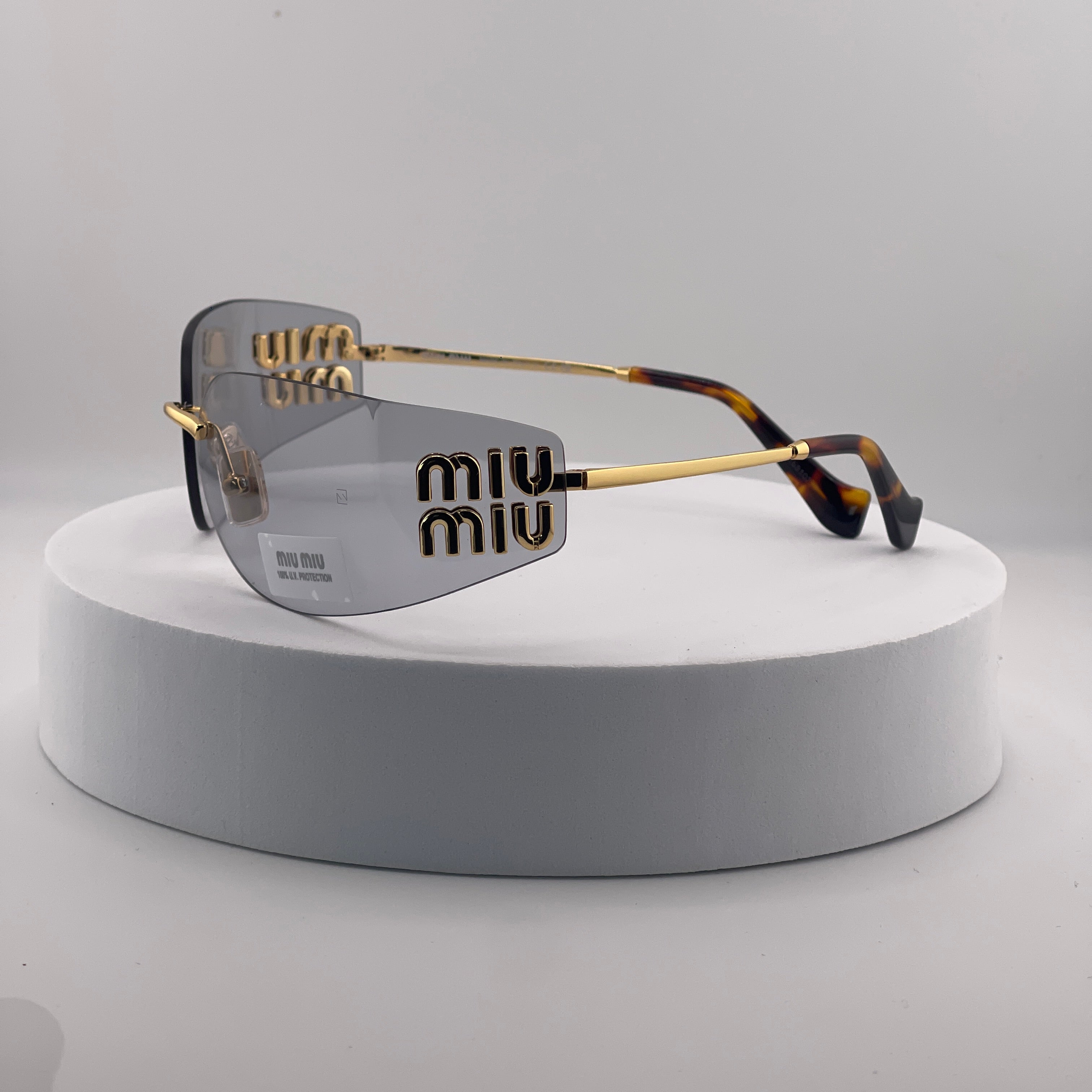 Miu Miu MU 54YS Rimless Sunglasses – Gold Frame / light grey Lenses