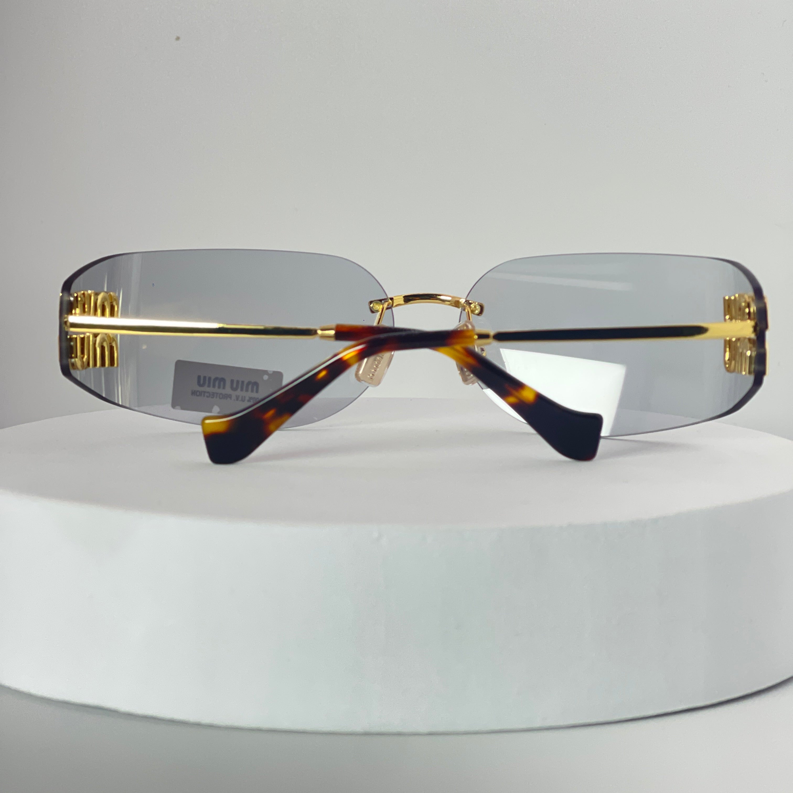 Miu Miu MU 54YS Rimless Sunglasses – Gold Frame / light grey Lenses